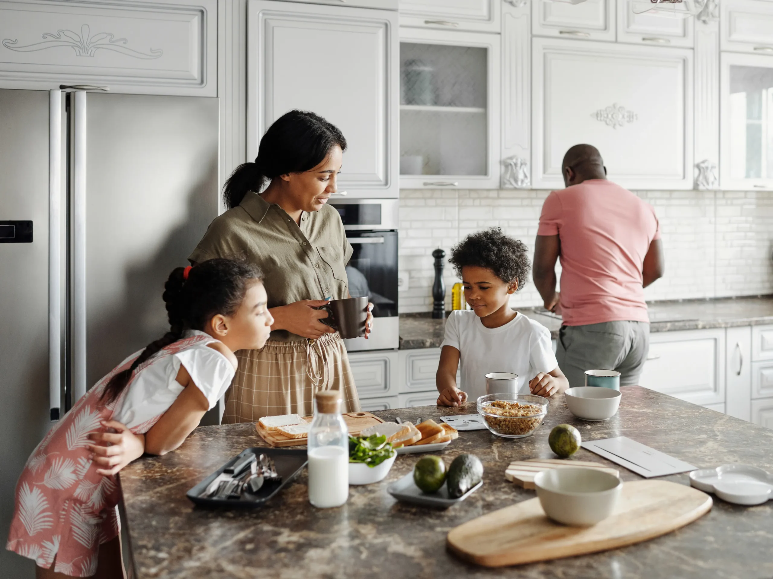 family eating a meal and cooking in the kitchen - how to keep your home comfortable