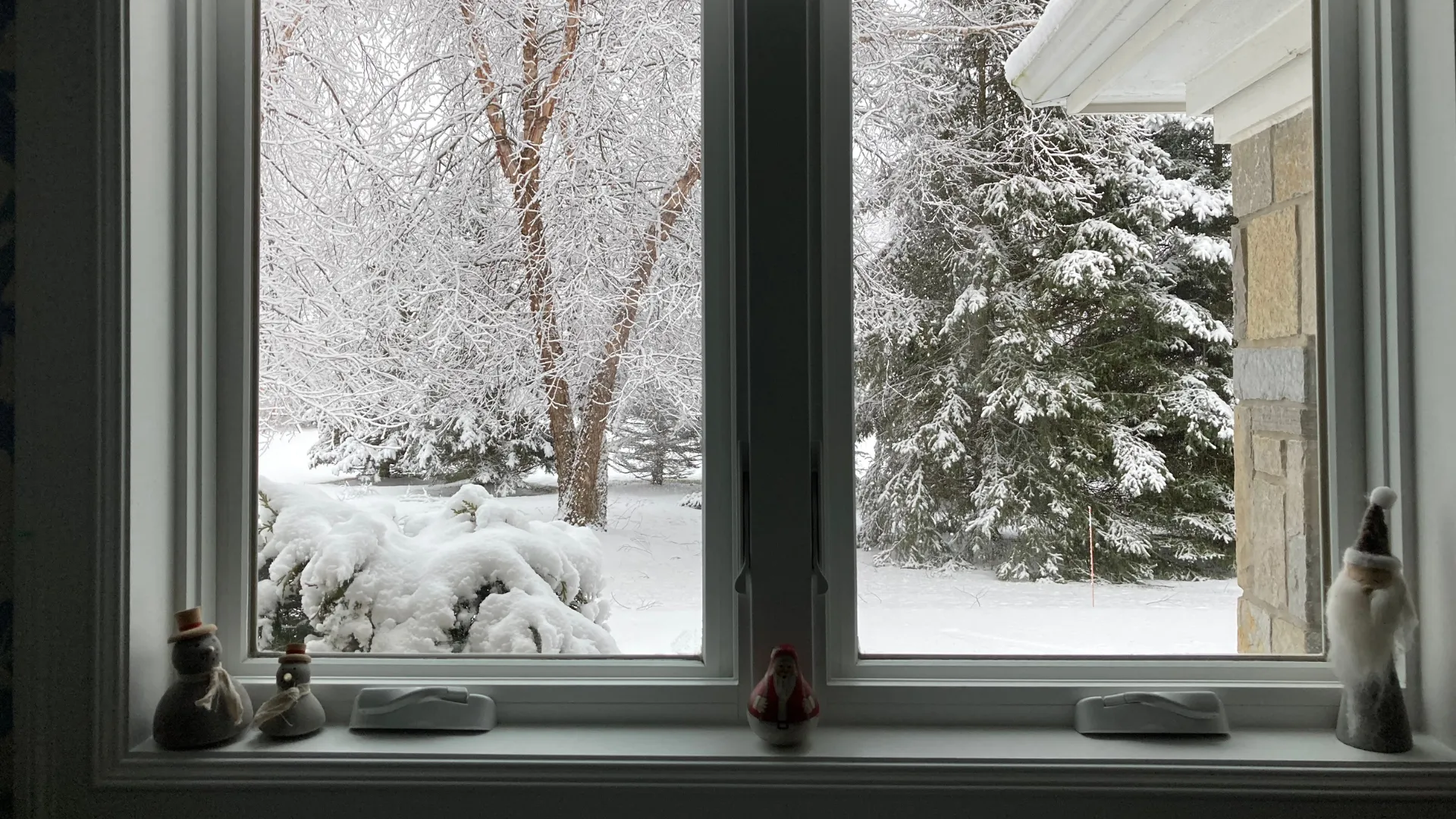 window looking out to a snowy day in winter