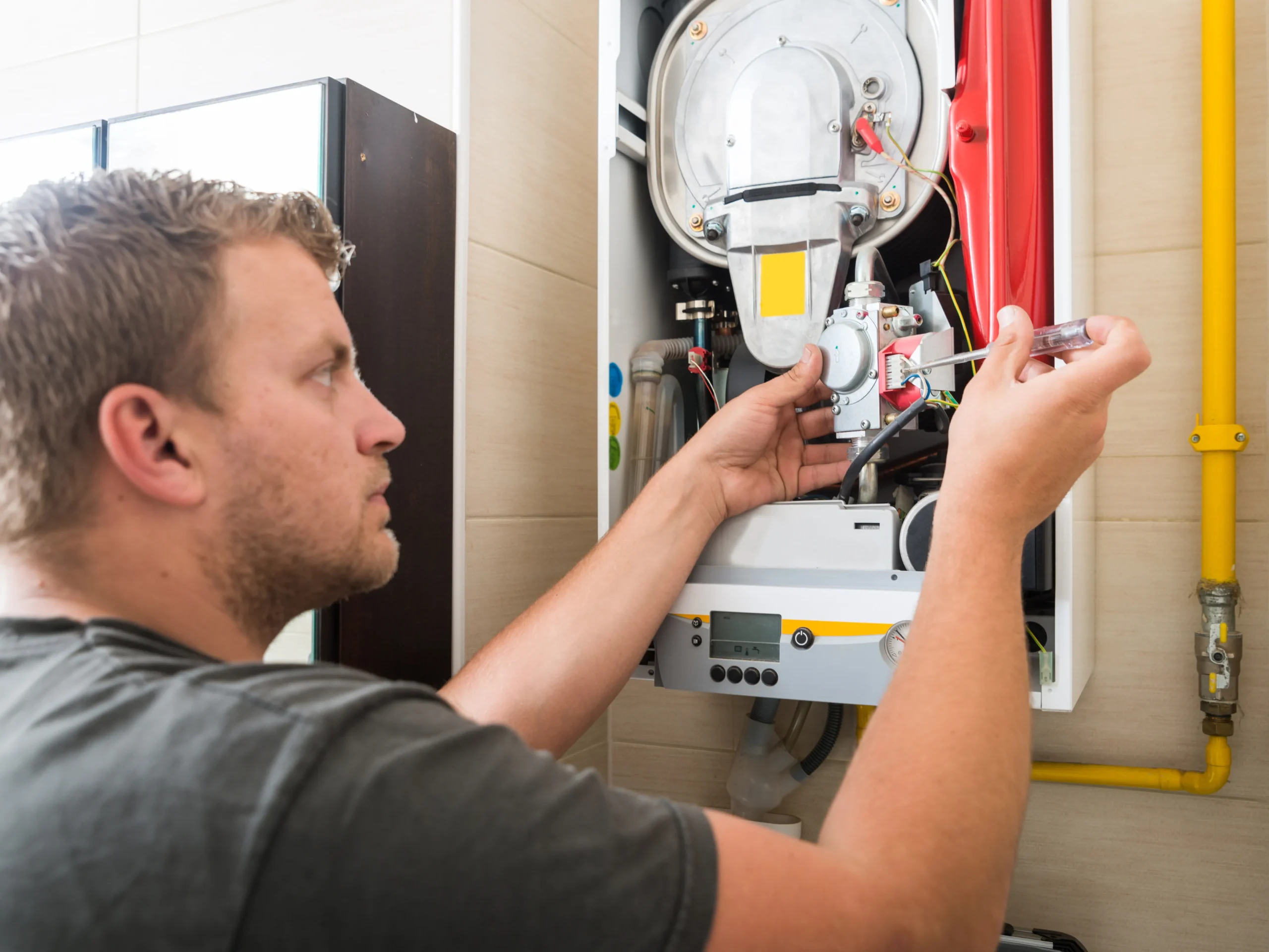 man working on furnace because furnace failing to blow hot air