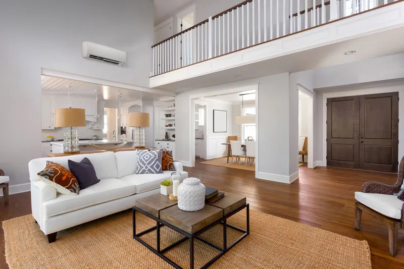 living room with white couch and yellow carpet